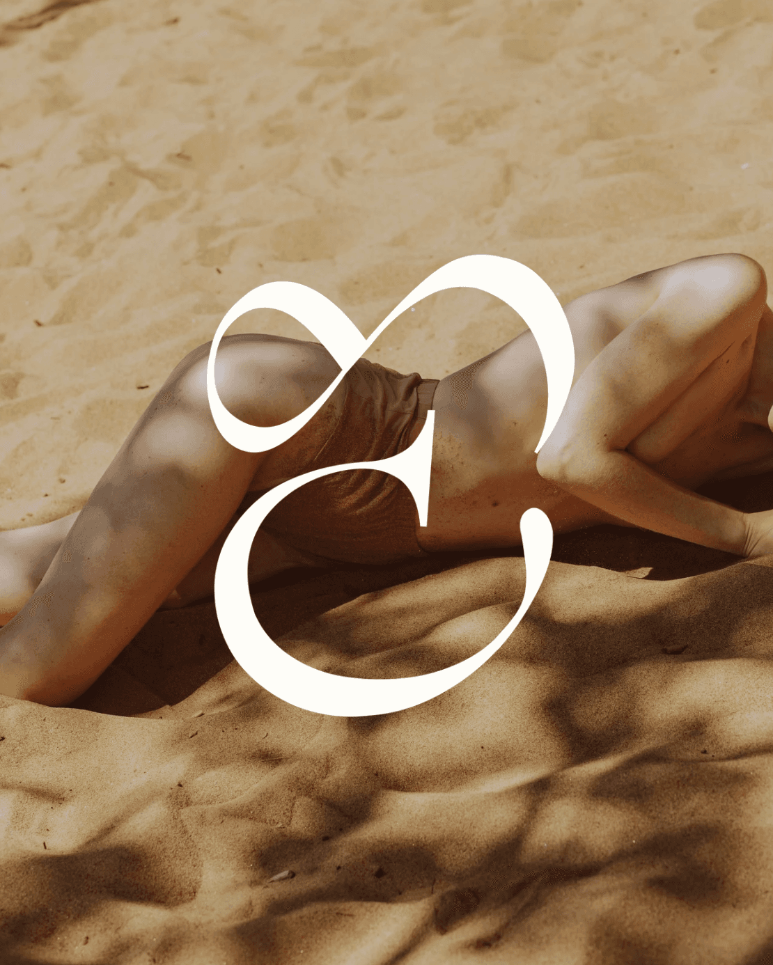 Sun-kissed skin glowing on warm sand with the ELIO LUX monogram