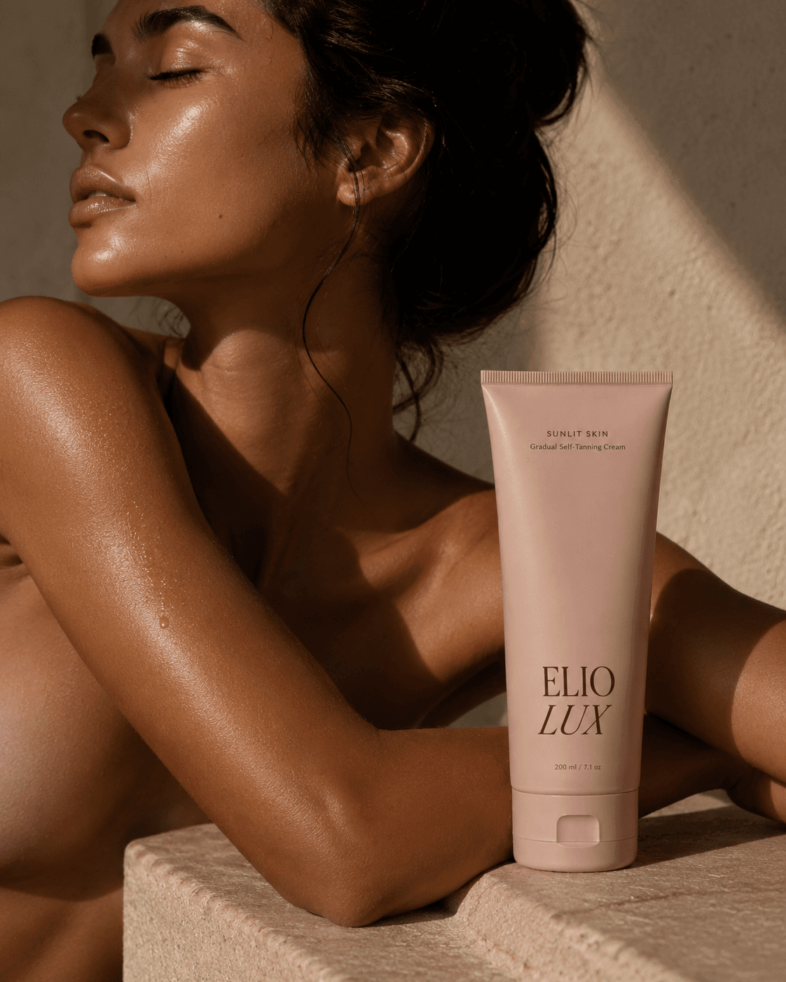 ELIO LUX Sunlit Skin held by a sun-kissed model